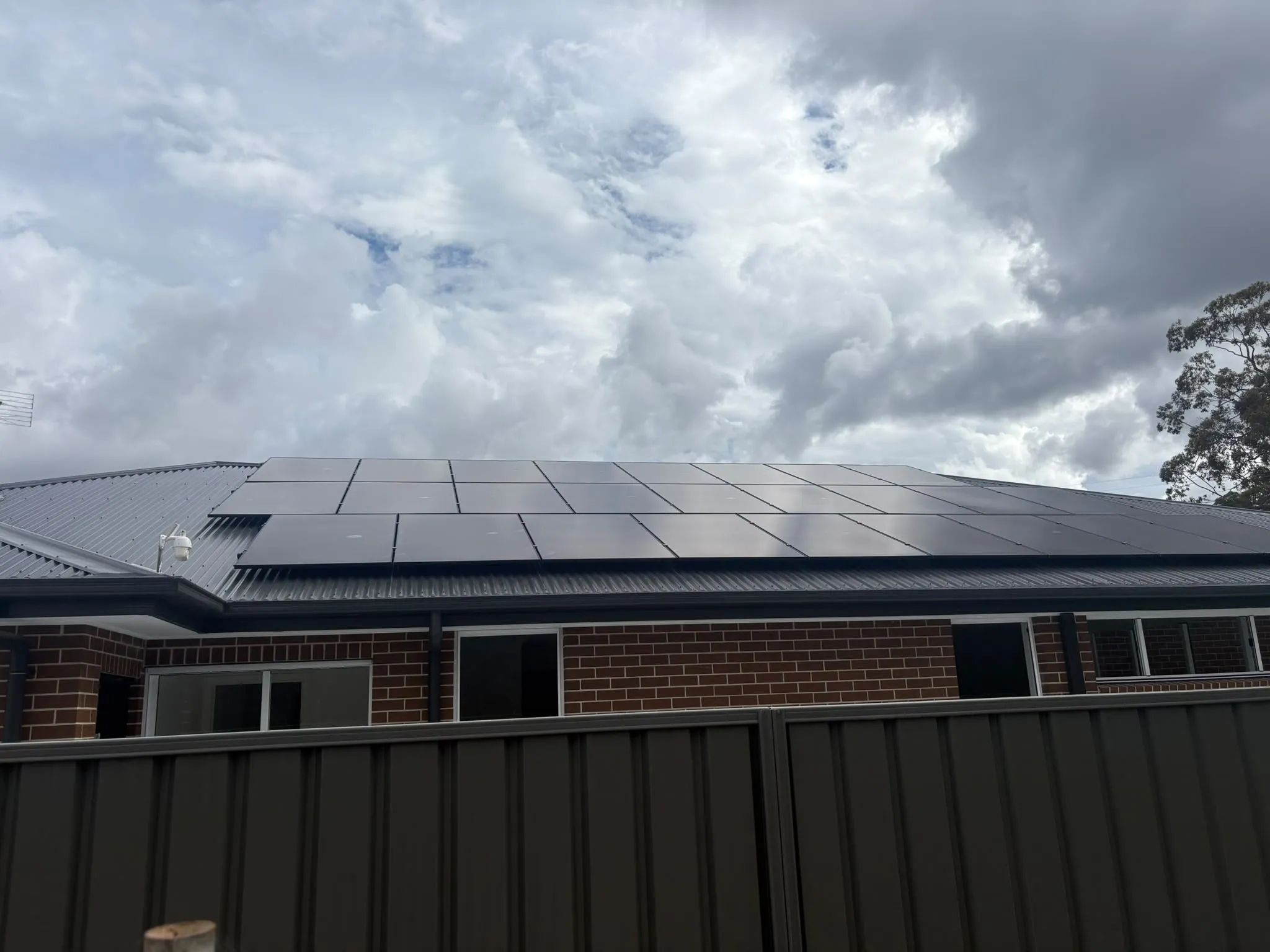 All-black AIKO Neostar solar panels on the roof of a brick home